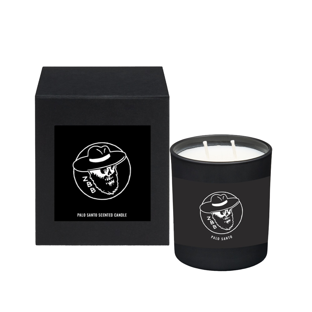 Black scented candle with a skull logo in packaging.