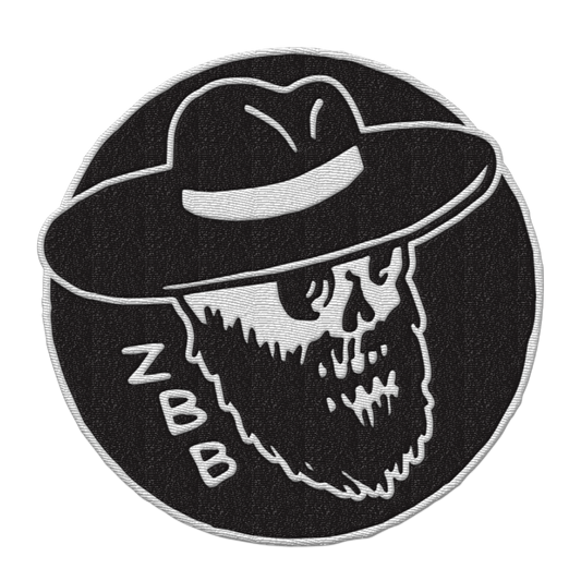 Circular embroidered patch featuring a bearded skull wearing a wide-brimmed hat, with ’ZBB’ text.