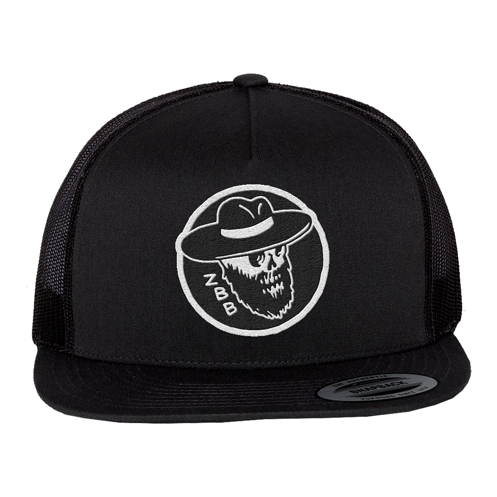 Black trucker hat with a white skull logo wearing a cowboy hat.