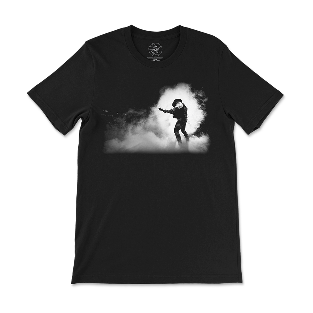 Black t-shirt with a silhouette design of a guitarist performing in smoke or fog.