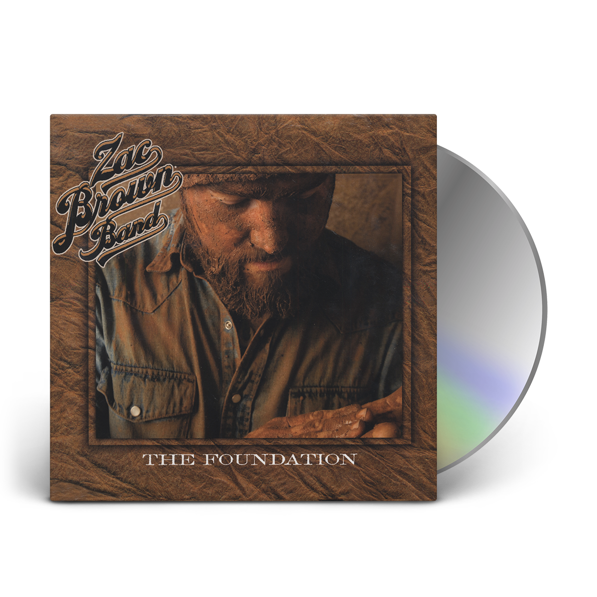 Album cover for ’The Foundation’ by Zac Brown Band featuring a CD and a sepia-toned photograph of a bearded man in a button-up shirt.