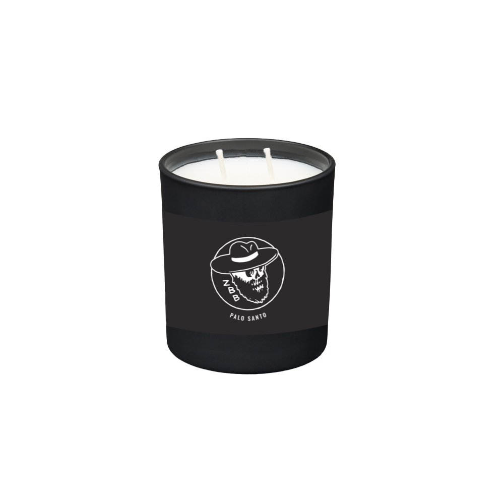 Black candle jar with a skull wearing a cowboy hat logo and ’Palo Santo’ text.