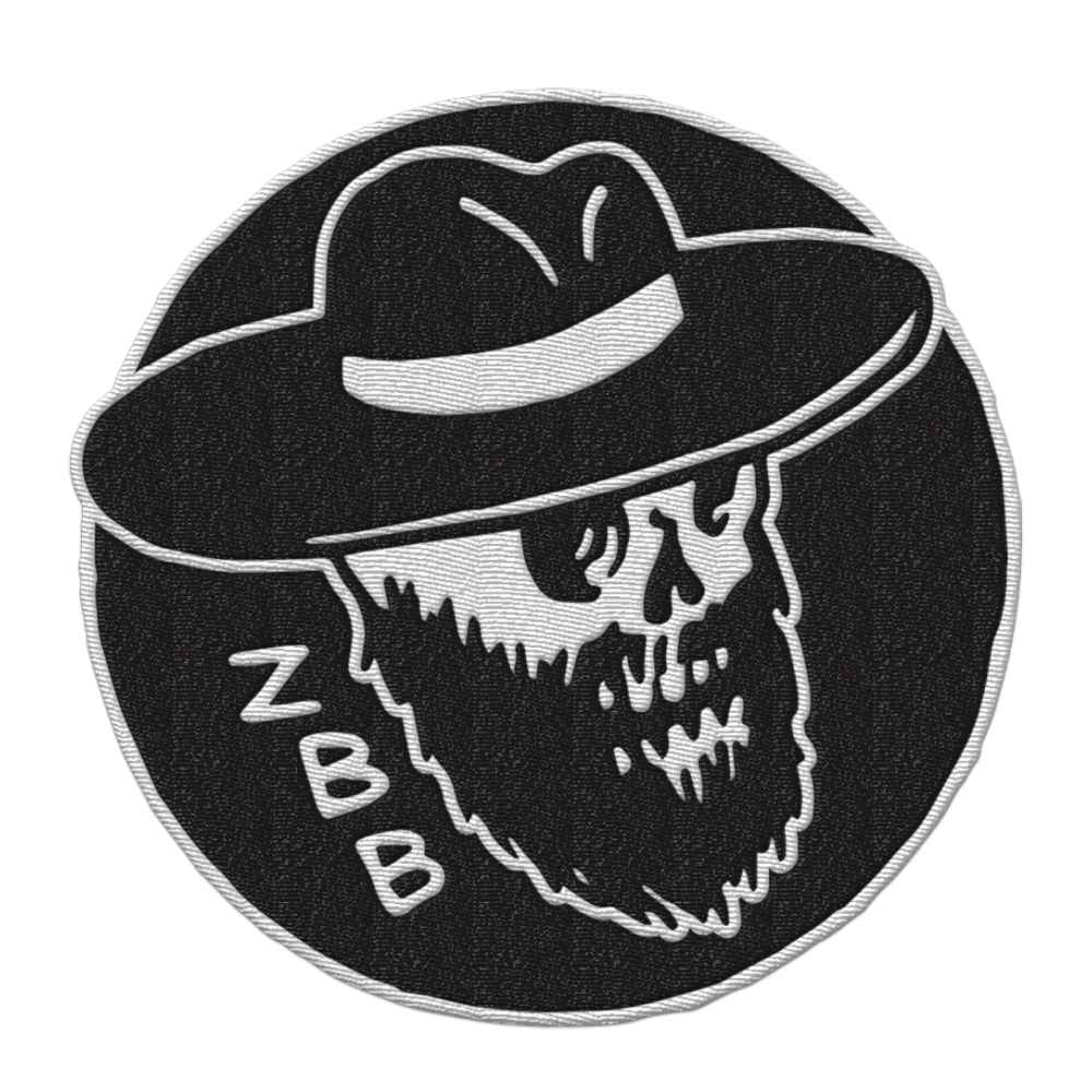 Circular embroidered patch featuring a bearded skull wearing a wide-brimmed hat, with ’ZBB’ text.