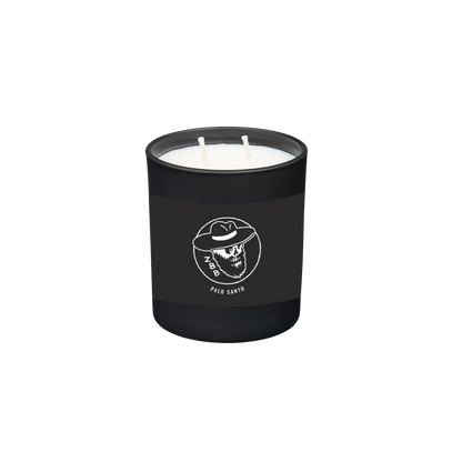 Black candle jar with a skull wearing a cowboy hat logo and ’Palo Santo’ text.