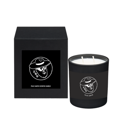 Black scented candle with a skull logo in packaging.