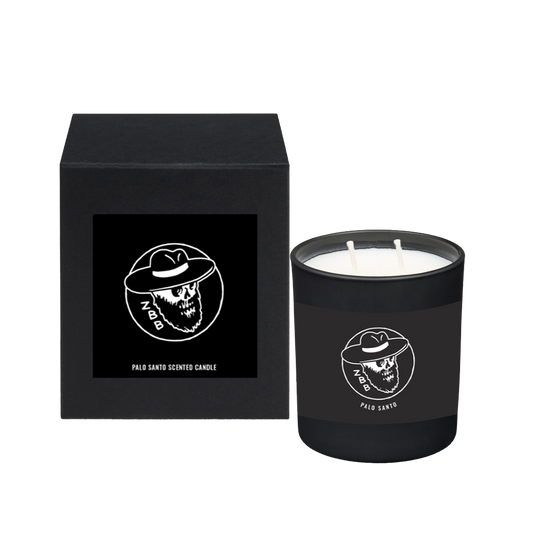 Black scented candle with a skull logo in packaging.
