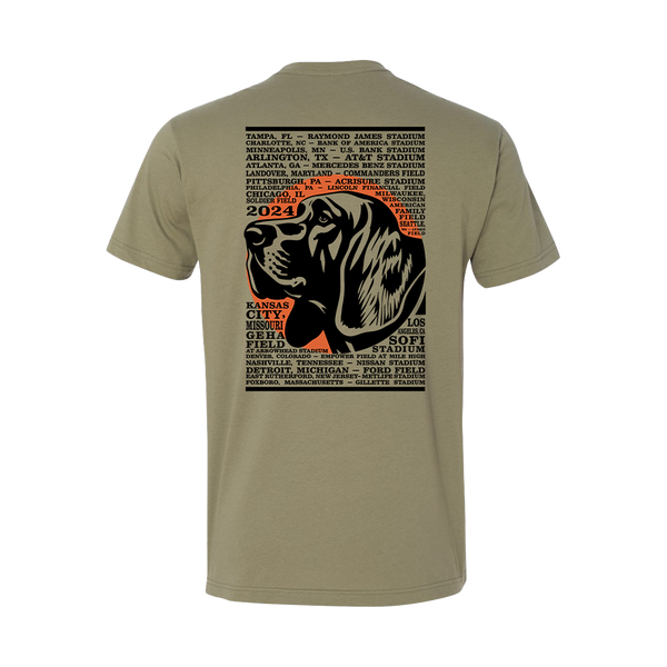 Tan t-shirt with a graphic design featuring a dog’s head and text listing various stadiums and cities.