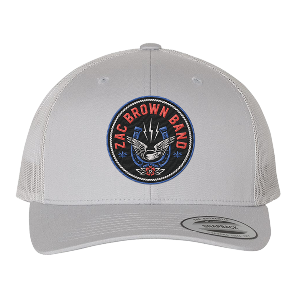 White trucker-style baseball cap with a circular ’Zac Brown Band’ logo patch on the front.