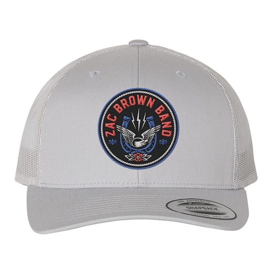 White trucker-style baseball cap with a circular ’Zac Brown Band’ logo patch on the front.