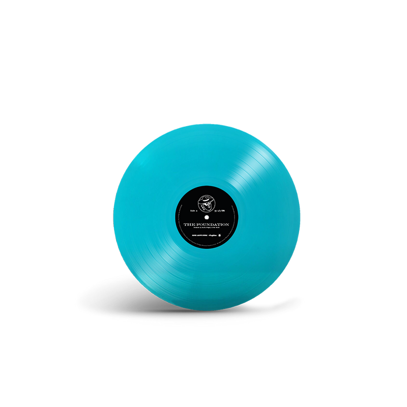 Bright turquoise vinyl record with a black label in the center.