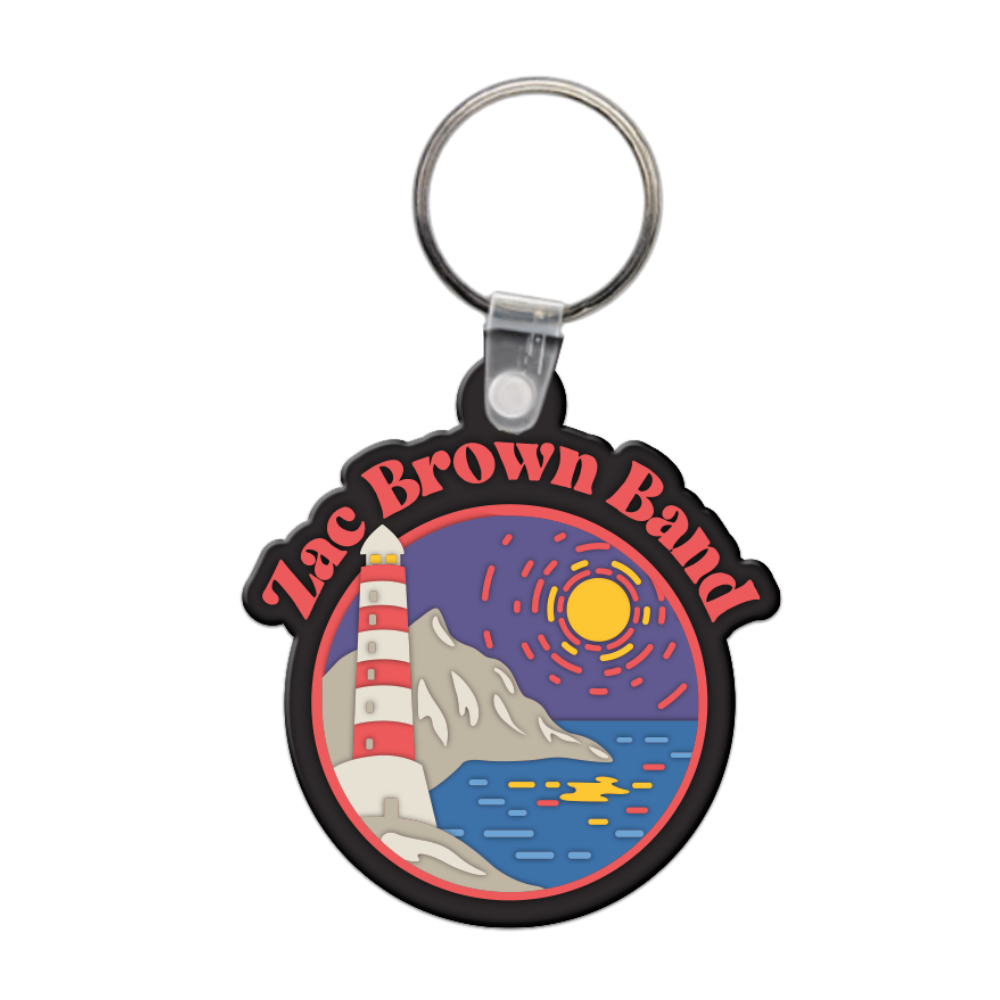 Keychain featuring a colorful circular design with ’Zac Brown Band’ text and a coastal scene including a lighthouse, mountain, and sunset.