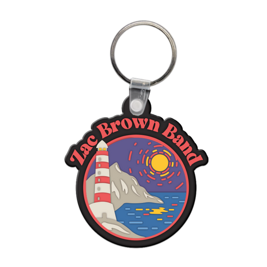 Keychain featuring a colorful circular design with ’Zac Brown Band’ text and a coastal scene including a lighthouse, mountain, and sunset.