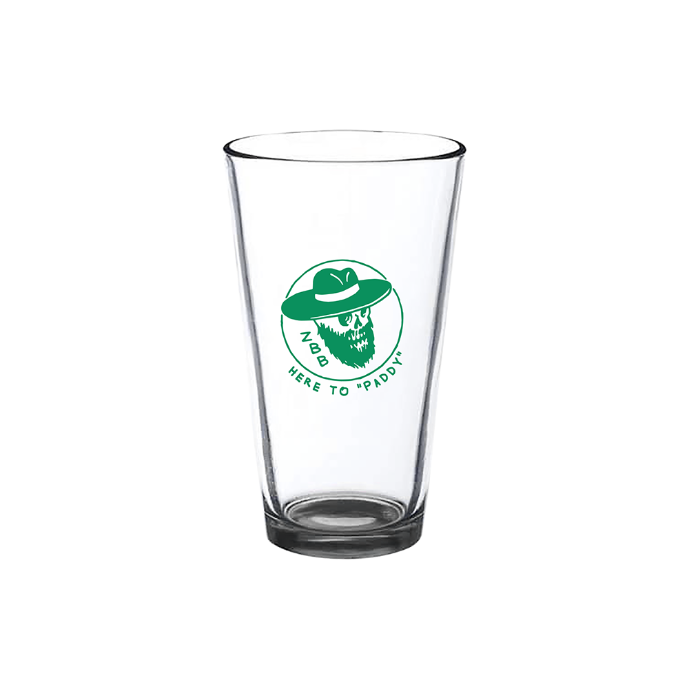 Clear glass pint glass with a green logo featuring a bearded face in a hat and the text ’HERE TO PADDY’.