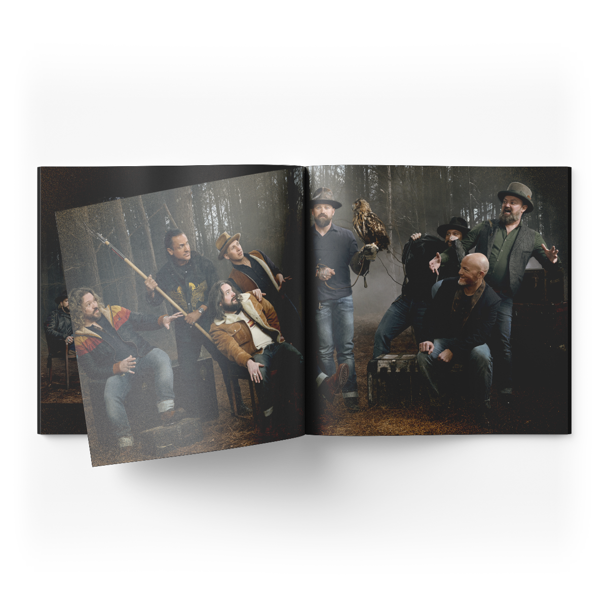 Open book displaying a dramatic group photograph of several people in a misty forest setting.