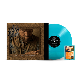 Vinyl record album titled ’The Foundation’ by Zac Brown Band, with a turquoise-colored vinyl disc and accompanying guitar pick package.