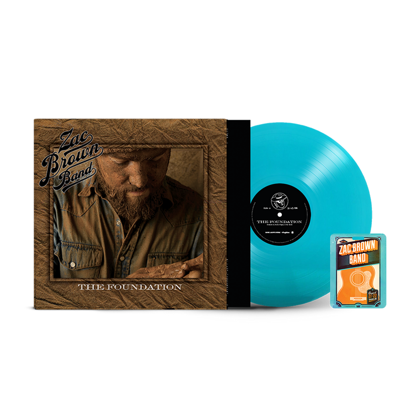 Vinyl record album titled ’The Foundation’ by Zac Brown Band, with a turquoise-colored vinyl disc and accompanying guitar pick package.