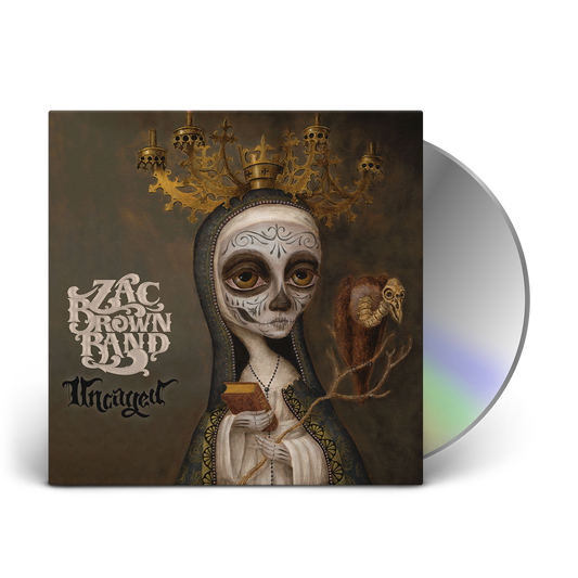Album cover featuring a surreal Day of the Dead-inspired figure wearing an ornate crown and holding a small creature.