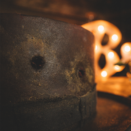 Weathered concrete block with a small hole, positioned near a glowing decorative object.