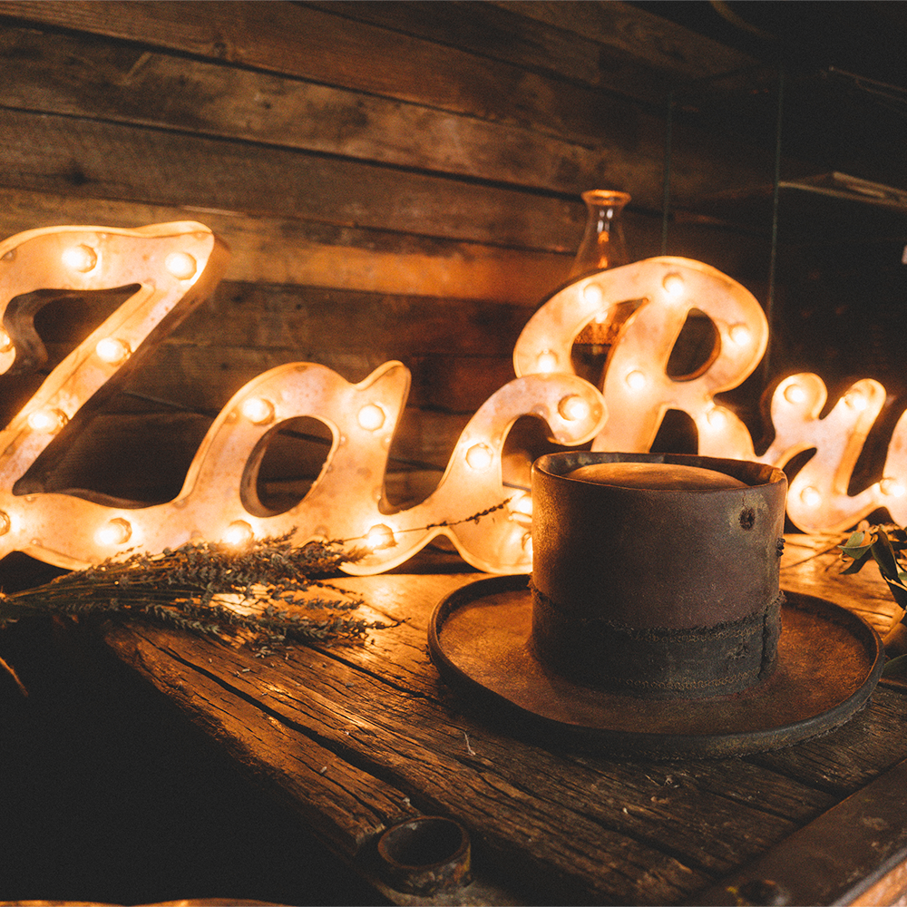 Illuminated ’ZaBu’ sign with a cup of coffee in front.