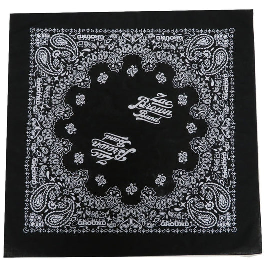 Black bandana with intricate white paisley and floral patterns featuring ’Zac Brown Band’ text in the center.